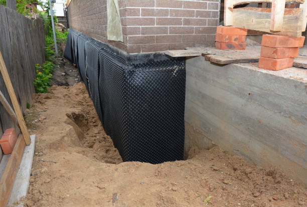 Happy homeowners after waterproofing job in Mathews